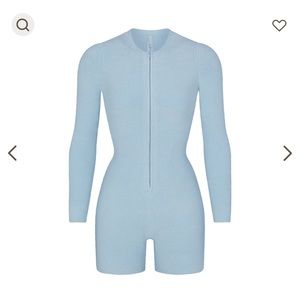 Skims “light cozy onesie” in size medium color denim
